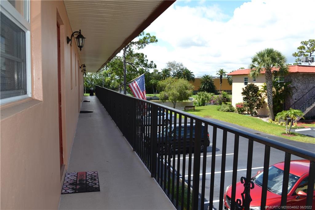 1969 Southwest Palm City Road, Unit G Stuart, FL 34994 - Photo 6 of 76 a view of a balcony with wooden fence