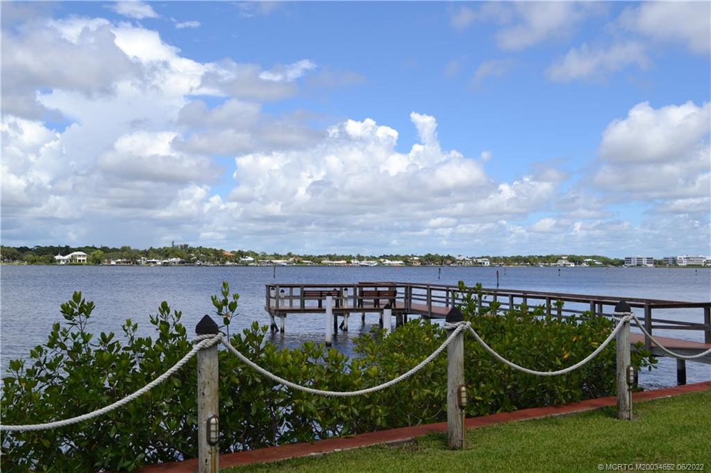 1969 Southwest Palm City Road, Unit G Stuart, FL 34994 - Photo 73 of 76 a view of a lake with a swimming pool and outdoor seating