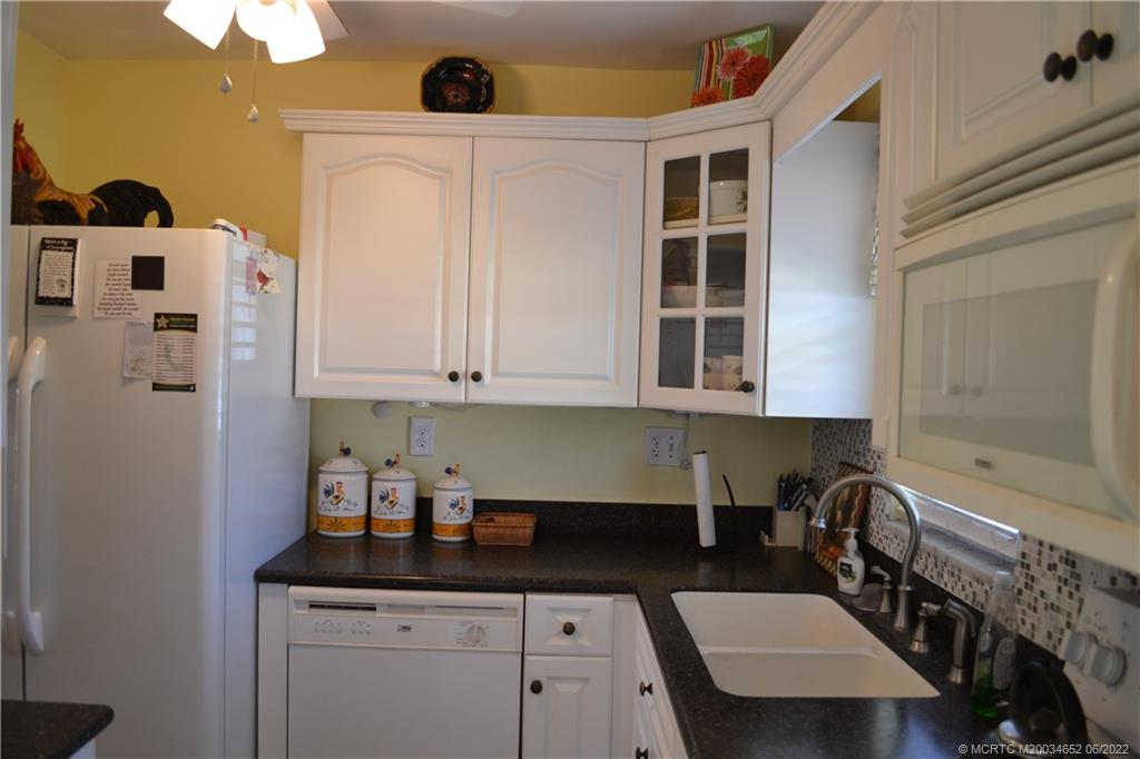 1969 Southwest Palm City Road, Unit G Stuart, FL 34994 - Photo 9 of 76 a kitchen with stainless steel appliances a sink and cabinets