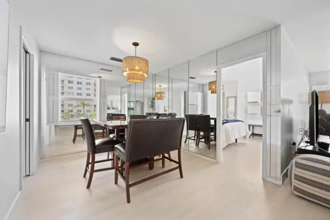 a living room with furniture and a washing machine with wooden floor