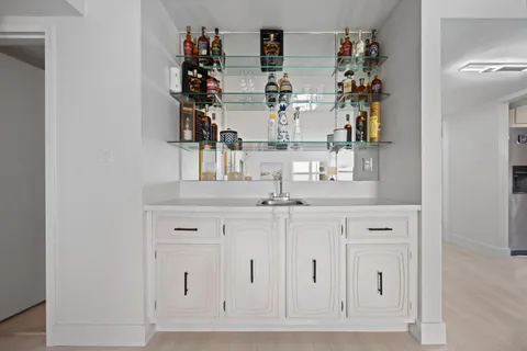 a view of a dining room with furniture and a chandelier