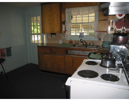 9 Leroy Road Lexington, MA 02421 - Photo 4 of 9 a kitchen with a stove and a white cabinet