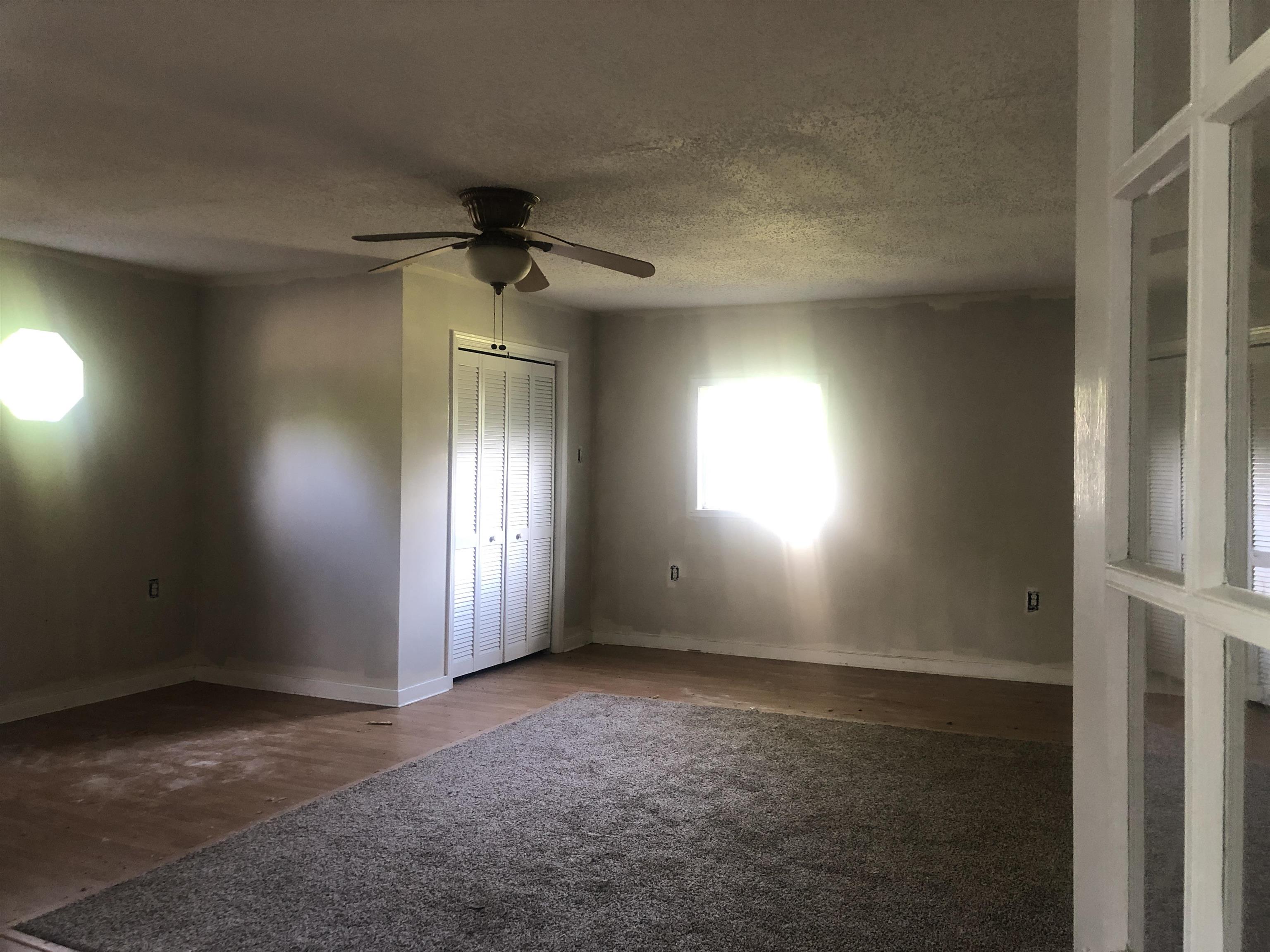 3688 Graves Road Memphis, TN 38116 - Photo 3 of 23 an empty room with windows and fan
