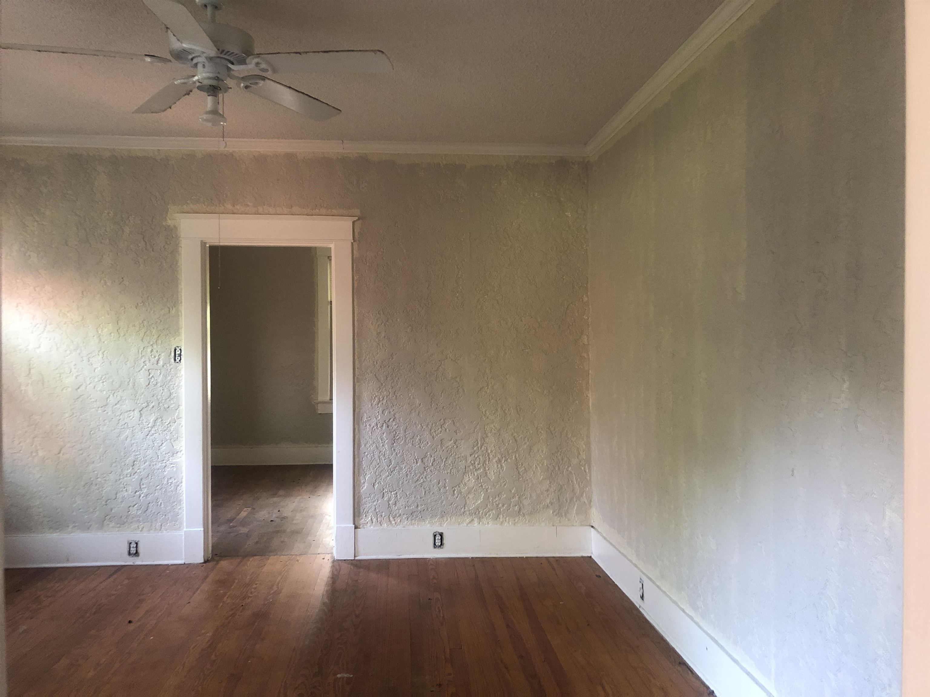 3688 Graves Road Memphis, TN 38116 - Photo 6 of 23 an empty room with a ceiling fan and wooden floor
