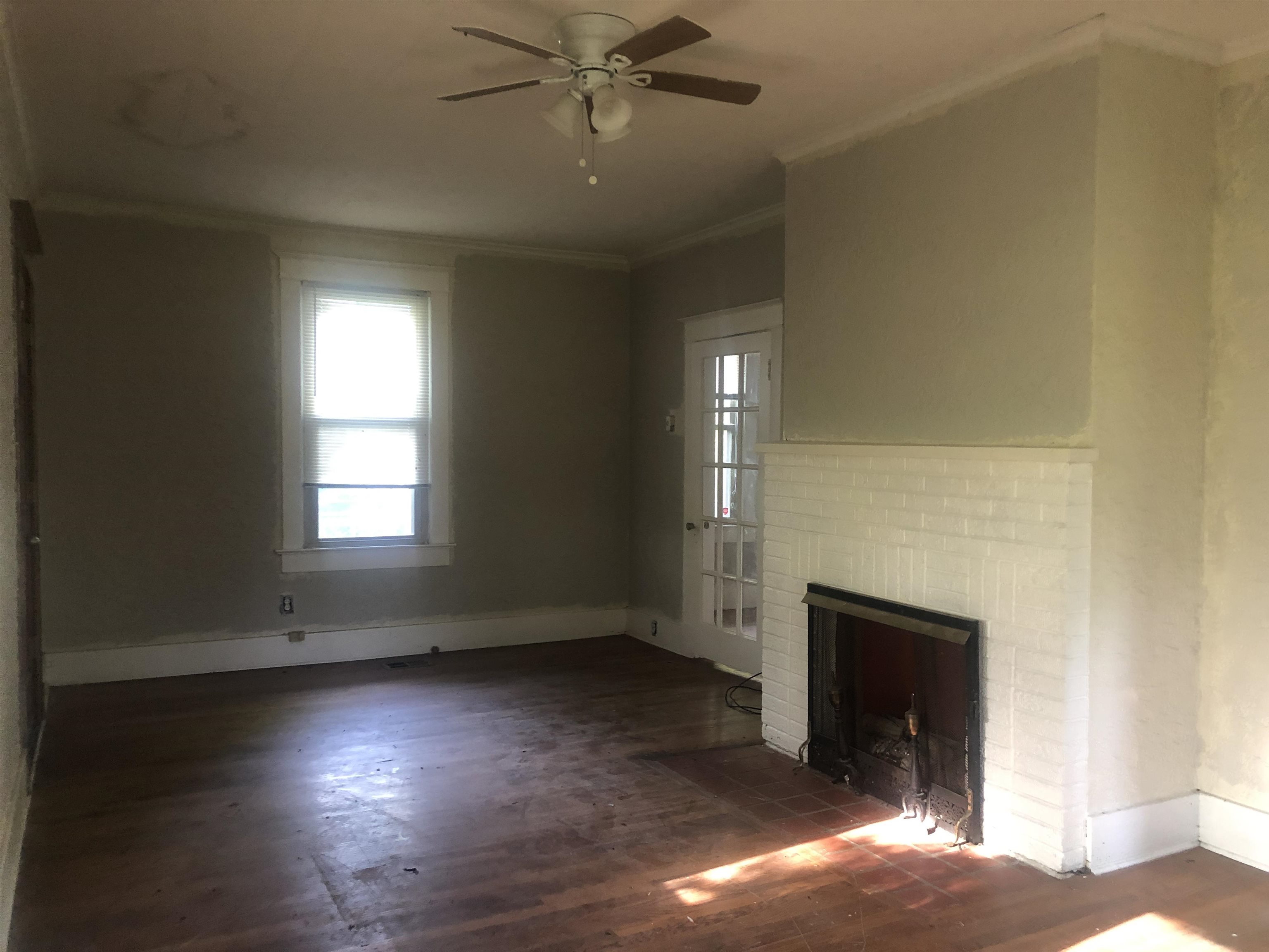 3688 Graves Road Memphis, TN 38116 - Photo 9 of 23 an empty room with windows and fireplace