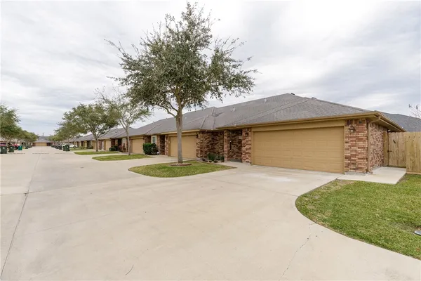 a view of a house with a yard and garage