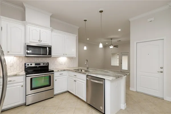 a kitchen with a stove sink and refrigerator