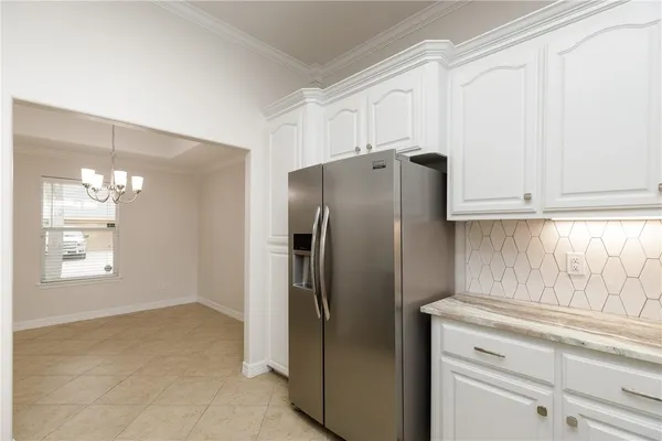 a kitchen with stainless steel appliances a refrigerator and cabinets
