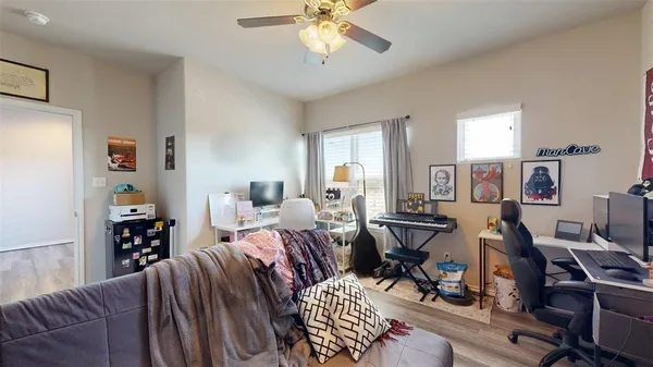 a living room with furniture a fireplace and a window