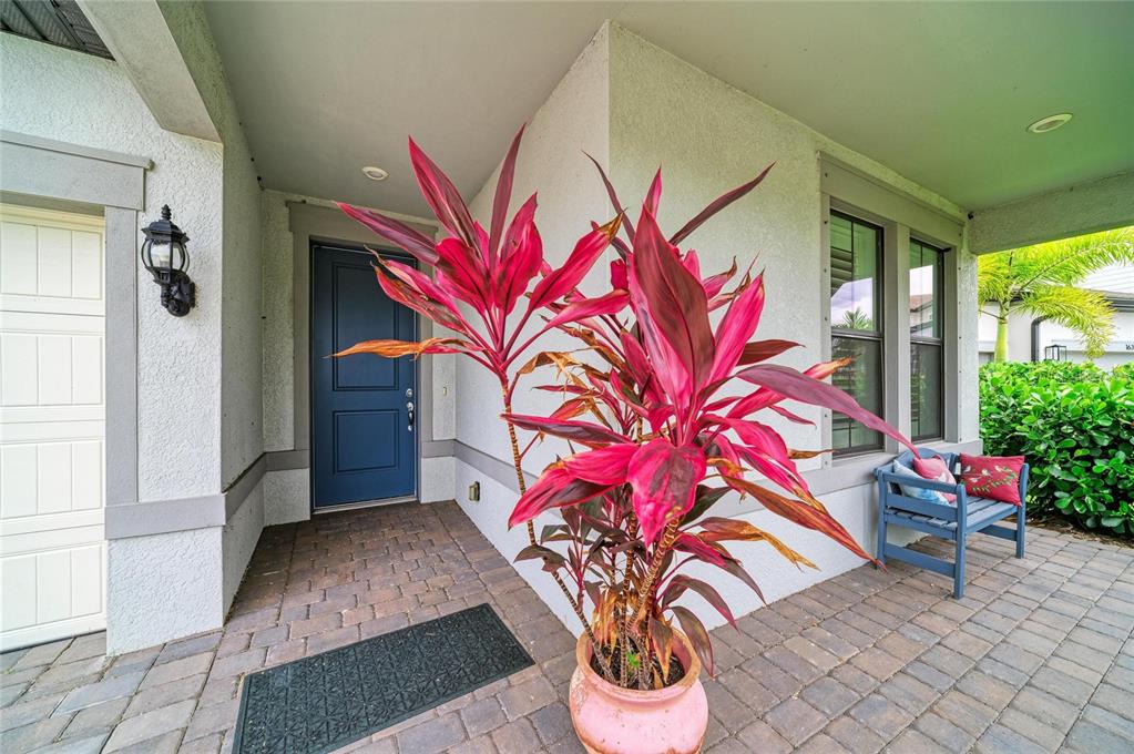 16341 Hidden Oak Loop Lakewood Ranch, FL 34211 - Photo 3 of 76 a vase of flowers sitting on a floor in front of a door