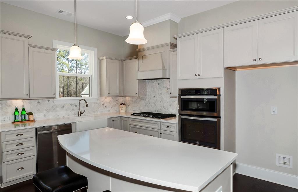 4316 Azalea Rdg Way Hoschton, GA 30548 - Photo 16 of 36 a kitchen with a white cabinets and white appliances