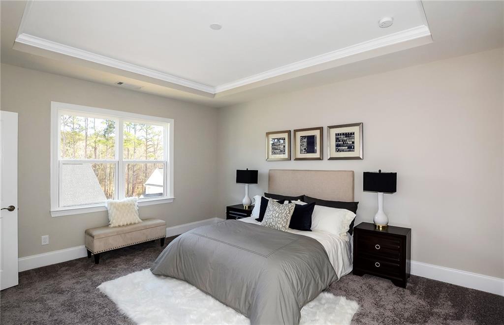 4316 Azalea Rdg Way Hoschton, GA 30548 - Photo 21 of 36 a bedroom with a bed and a window