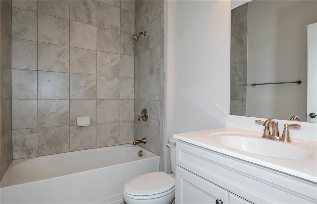 4316 Azalea Rdg Way Hoschton, GA 30548 - Photo 26 of 36 a bathroom with a sink a toilet and a bathtub