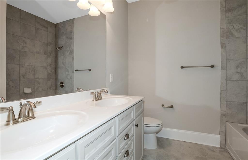 4316 Azalea Rdg Way Hoschton, GA 30548 - Photo 29 of 36 a bathroom with a sink a toilet and shower