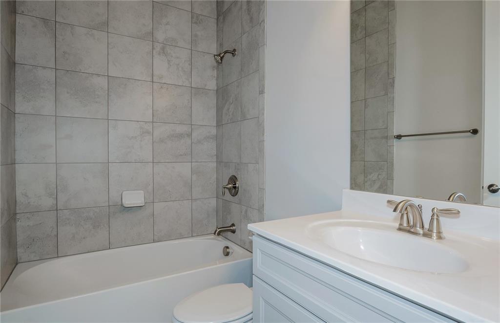 4316 Azalea Rdg Way Hoschton, GA 30548 - Photo 8 of 36 a bathroom with a granite countertop sink toilet and bathtub