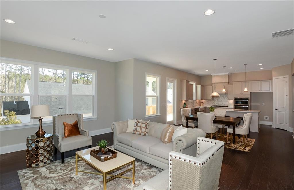 4316 Azalea Rdg Way Hoschton, GA 30548 - Photo 10 of 36 a living room with furniture and a large window