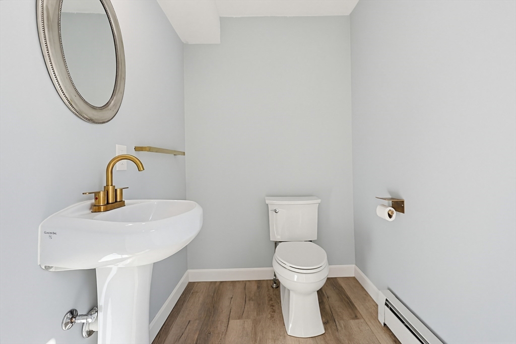 44 Clark Street Spencer, MA 01562 - Photo 26 of 41 a bathroom with a sink a toilet and a mirror