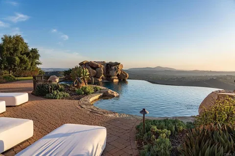 a view of a terrace with couches and sky view