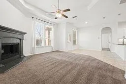 a view of an empty room with a fireplace and a window