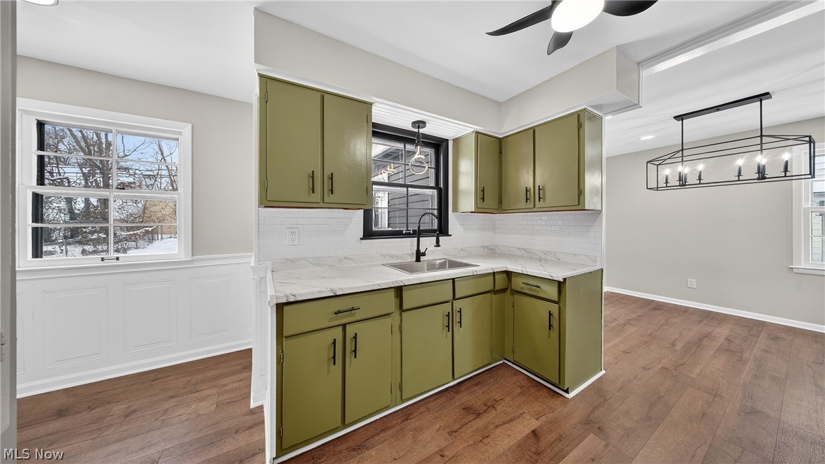 16811 Invermere Avenue Cleveland, OH 44128 - Photo 7 of 47 Kitchen featuring green cabinetry, decorative light fixtures, light countertops, healthy amount of natural light, and recessed lighting
