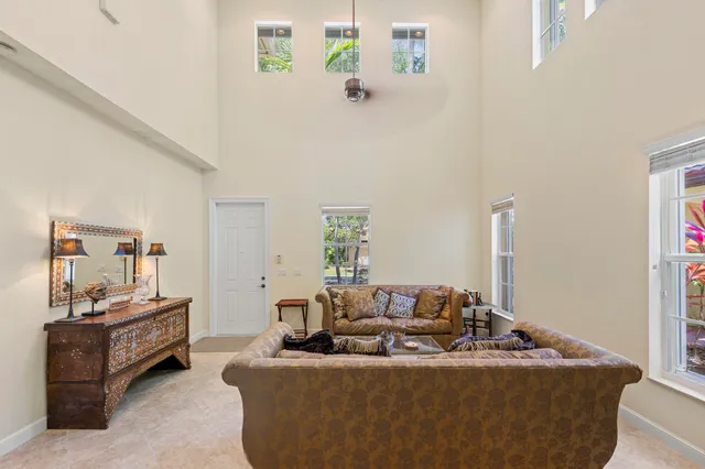 a dining room with furniture and a floor to ceiling window
