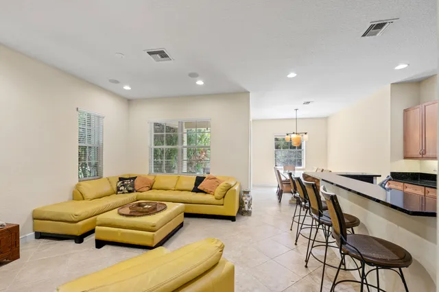 a kitchen with stainless steel appliances granite countertop a sink refrigerator and cabinets