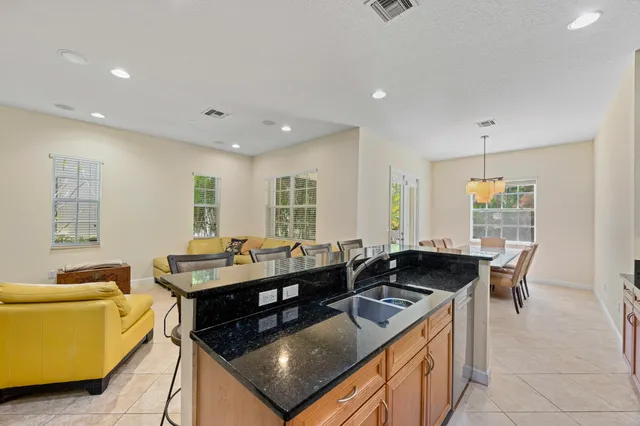 a kitchen with stainless steel appliances granite countertop a stove a sink and a refrigerator