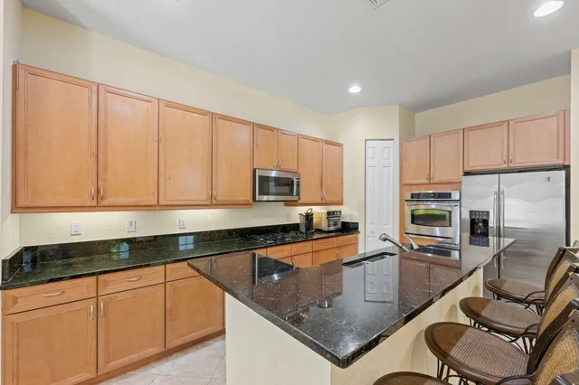 a large kitchen with a table and chairs