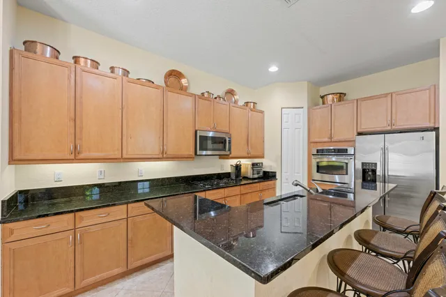 a bedroom with a bed and a flat tv screen on dresser