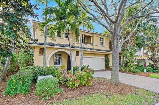a front view of a house with plants