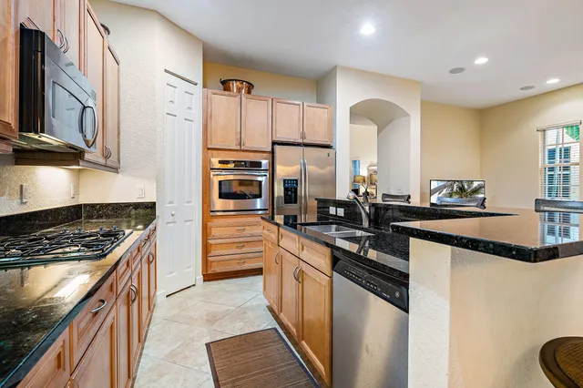 a bathroom with a double vanity sink mirror and shower