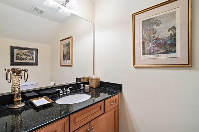 a bathroom with a double vanity sink mirror and chandelier