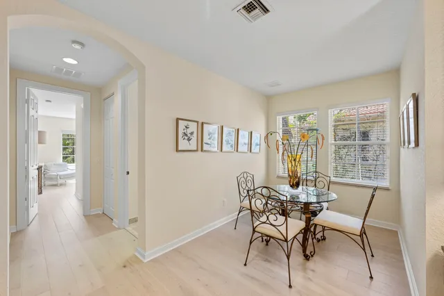 an aerial view of ocean and residential houses with outdoor space