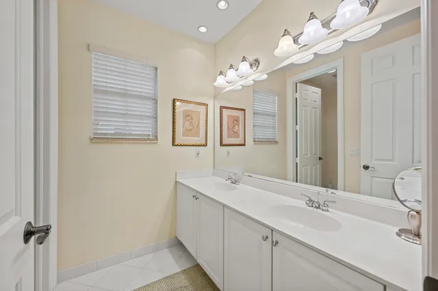 a large room with pool table and windows