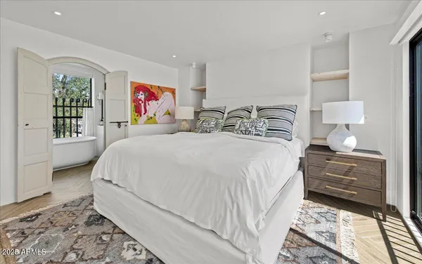 a bedroom with double bed and a window