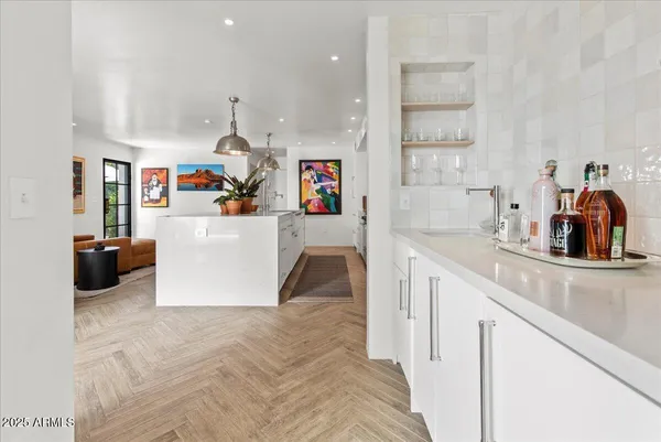a kitchen with a refrigerator and white cabinets