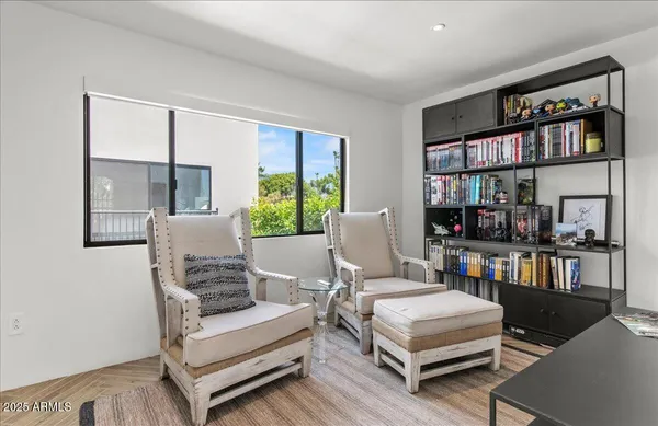 a living room with furniture a bookshelf and a book shelf