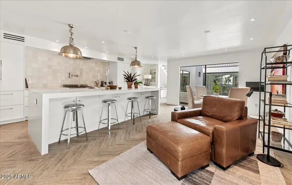 a living room with furniture and a kitchen view