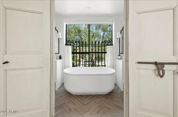 a white bath tub sitting next to a window