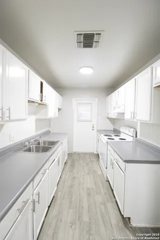 a large kitchen with a stove top oven
