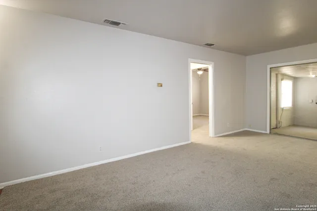 an empty room with windows and closet