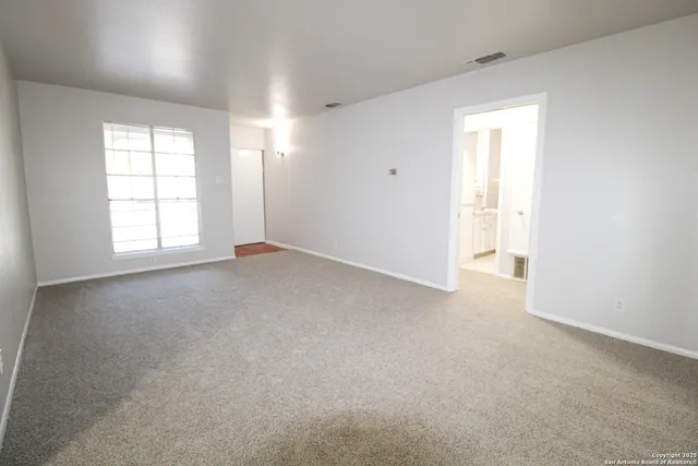 an empty room with windows and closet