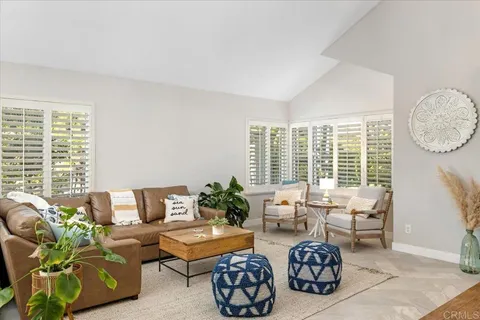 a view of a dining room with furniture a chandelier and wooden floor