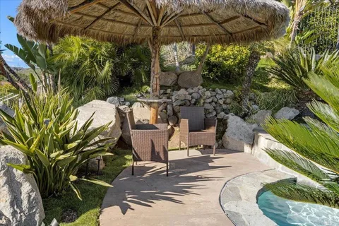a kitchen with a sink a counter top space cabinets and stainless steel appliances