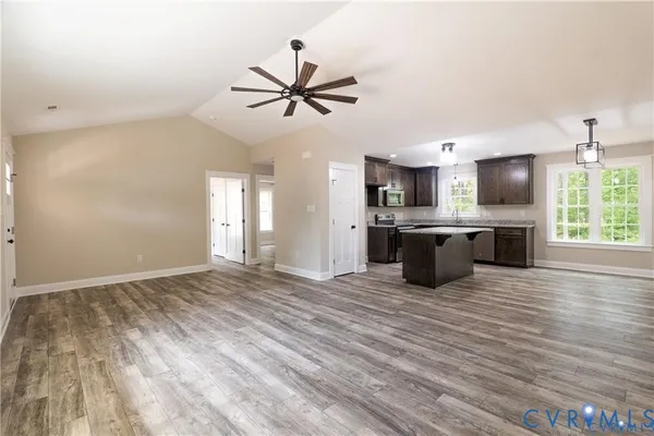 a view of a kitchen with a sink and cabinet wooden floor a chandelier
