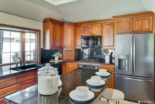 an aerial view of lake with residential houses with outdoor space and trees