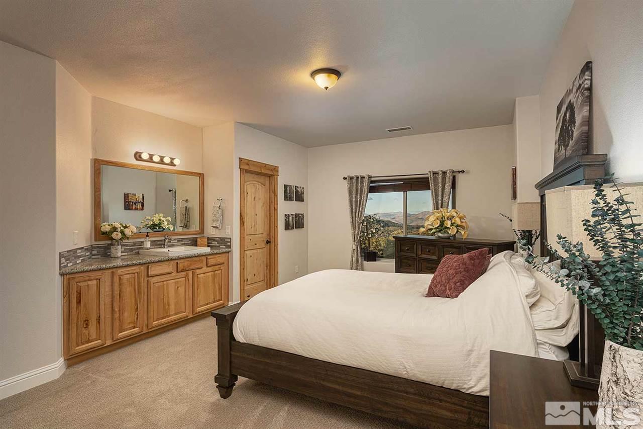 2001 Saddleback Road Reno, NV 89521 - Photo 21 of 25 a bedroom with a large bed and a chandelier