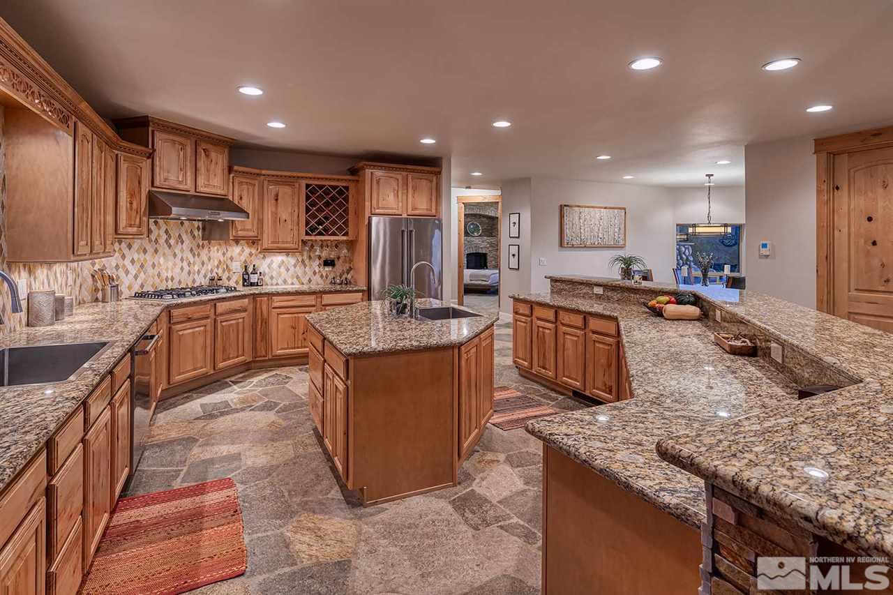2001 Saddleback Road Reno, NV 89521 - Photo 10 of 25 a kitchen with stainless steel appliances granite countertop a sink stove and refrigerator