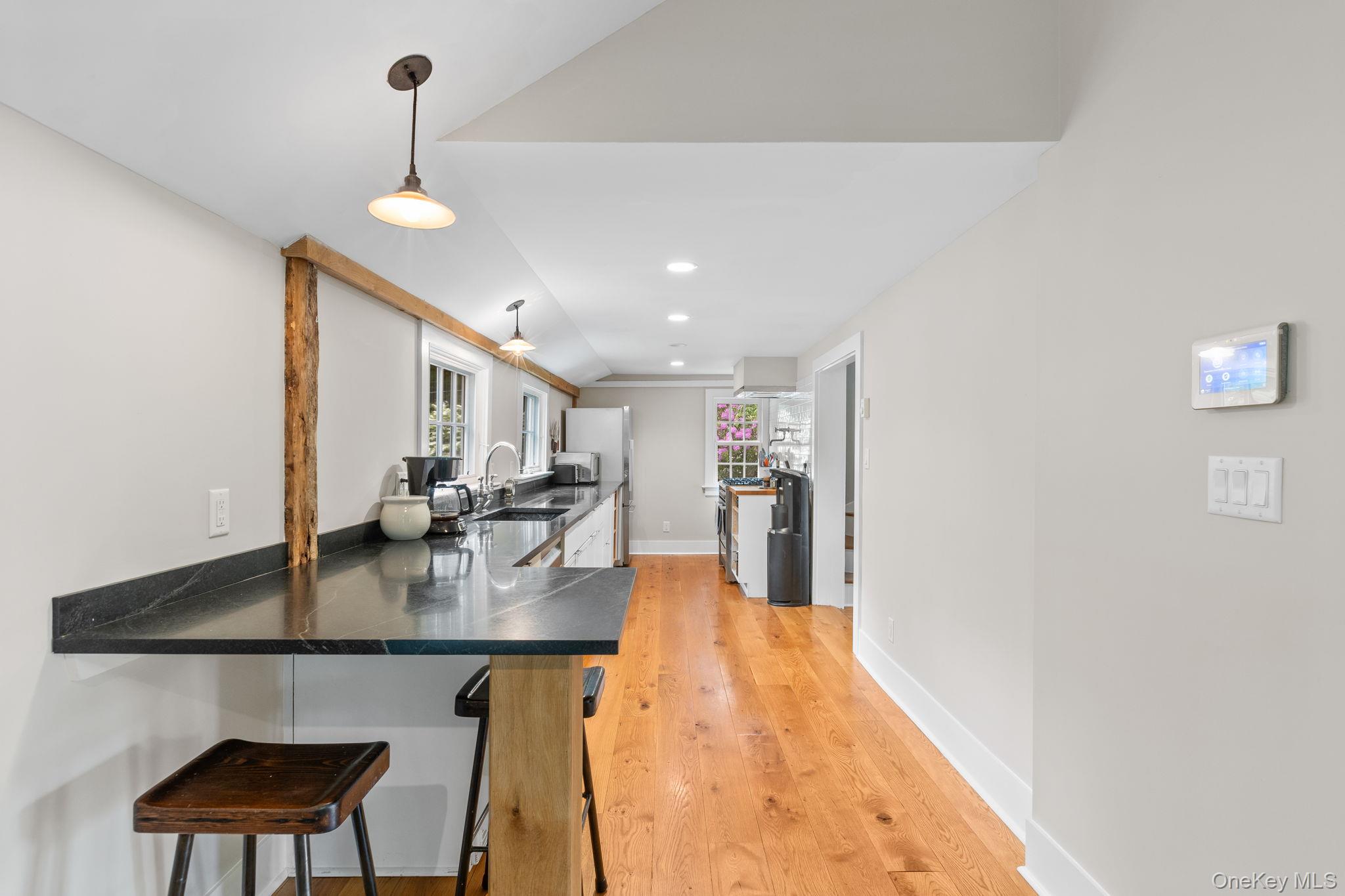 23 Pound Ridge Road Pound Ridge, NY 10576 - Photo 12 of 40 a kitchen with a dining table chairs and a wooden floor