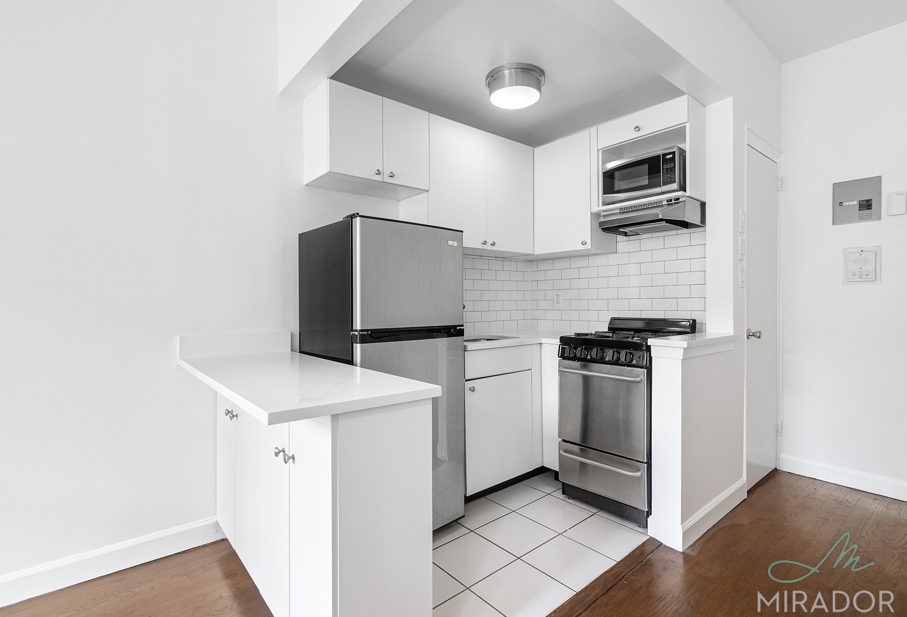 39 West 16th Street, Unit 5F Manhattan, NY 10011 - Photo 11 of 11 a kitchen with stainless steel appliances a refrigerator sink and microwave